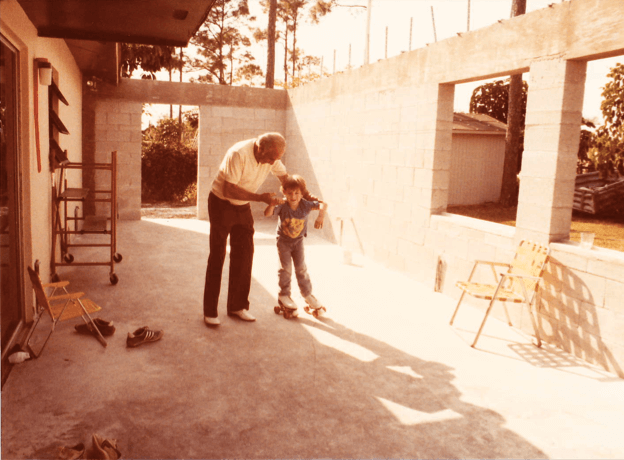 A man and boy are standing in the sun.