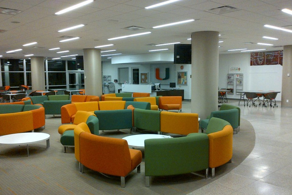 A room with many different colored chairs and tables.