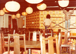 A person standing in front of some tables